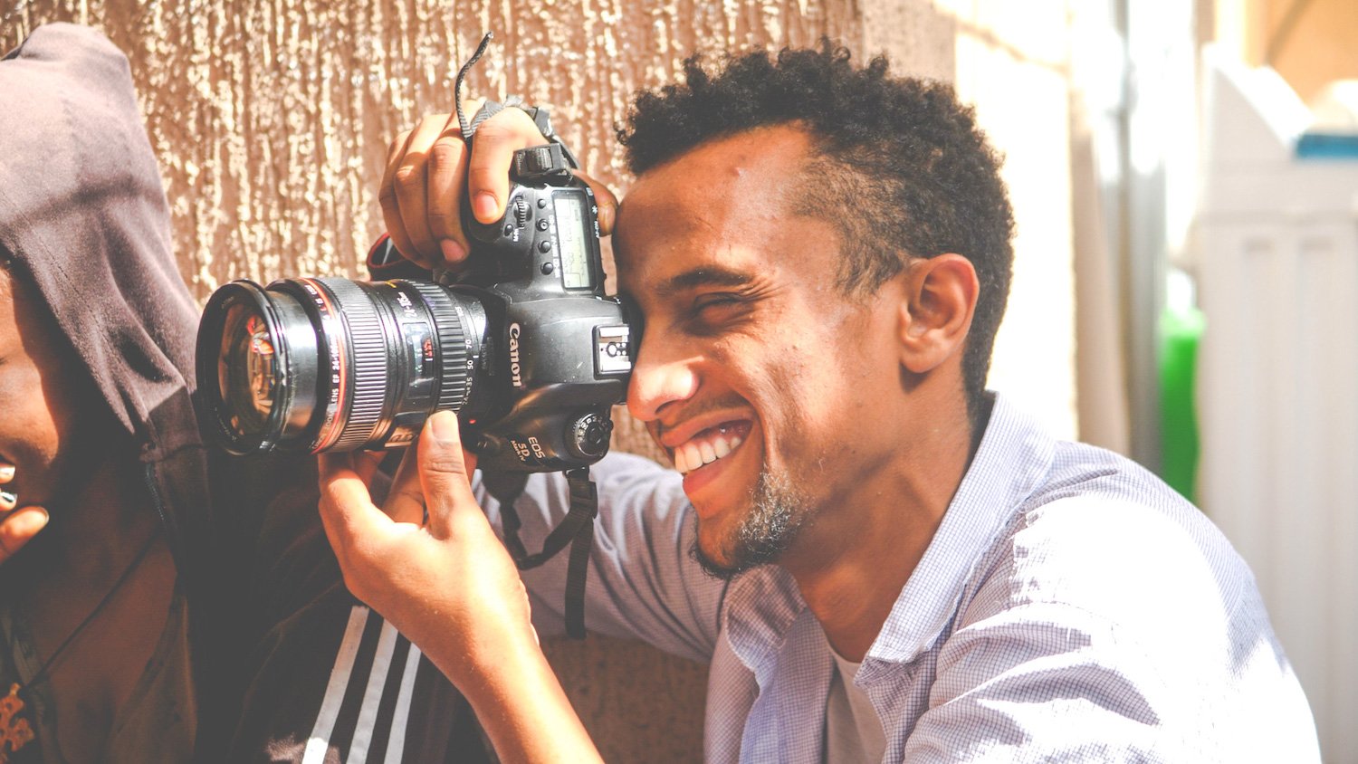 mehari-holding-camera